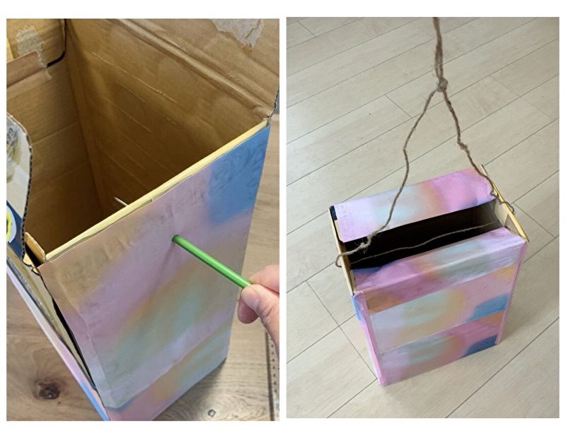 段ボールの両端にキリで穴を開けてその穴から紐を通している